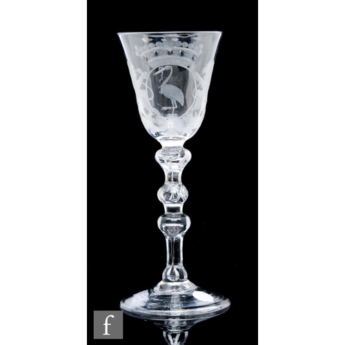 255 - An 18th Century Newcastle light baluster drinking glass circa 1750, the round funnel bowl engraved w... 