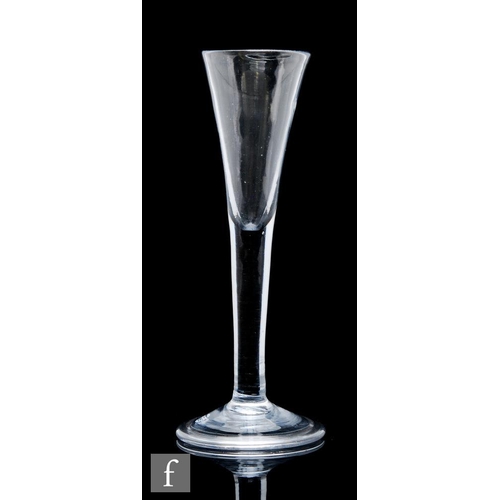 139 - An 18th Century Ratafia glass, the drawn trumpet bowl above a plain solid stem, raised to a conical ... 