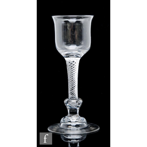 113 - An 18th Century composite stem drinking glass circa 1750, the waisted ovoid bowl with everted rim ab... 