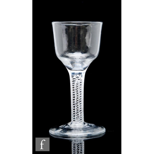 128 - An 18th Century drinking glass circa 1760, the ogee bowl above a mixed twist stem with four spiral t... 