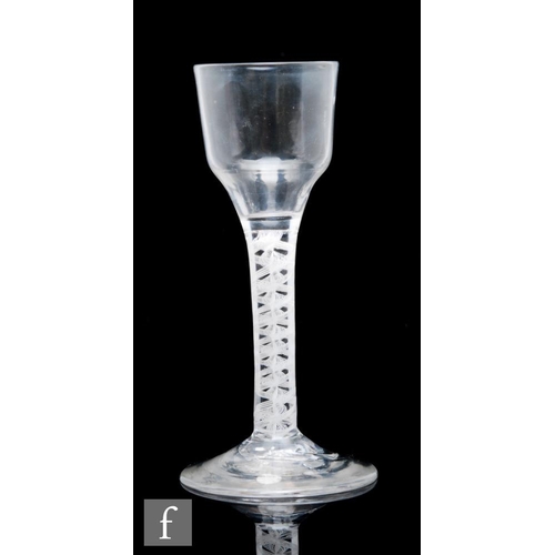 140 - An 18th Century drinking glass circa 1765, the ogee bowl above a triple series opaque twist stem, wi... 