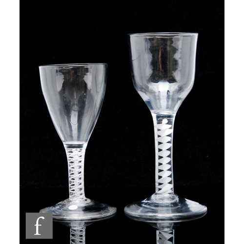 222 - An 18th Century wine glass circa 1765, the round funnel bowl above a double series opaque twist stem... 