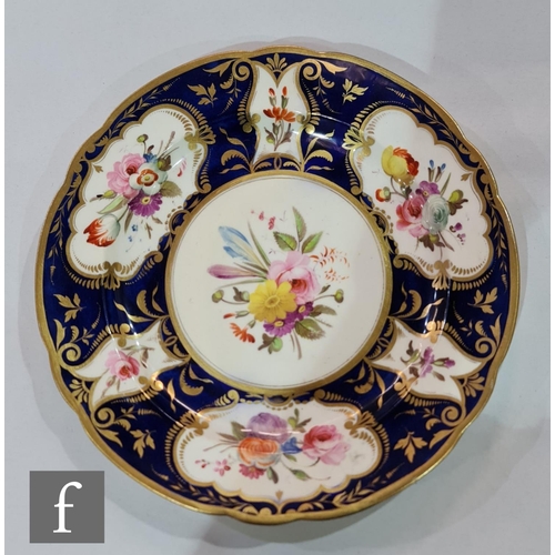 185 - A 19th Century shell shaped dish decorated to the centre with two stylised garden birds amidst a mou... 