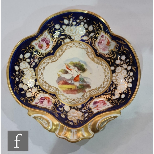 185 - A 19th Century shell shaped dish decorated to the centre with two stylised garden birds amidst a mou... 