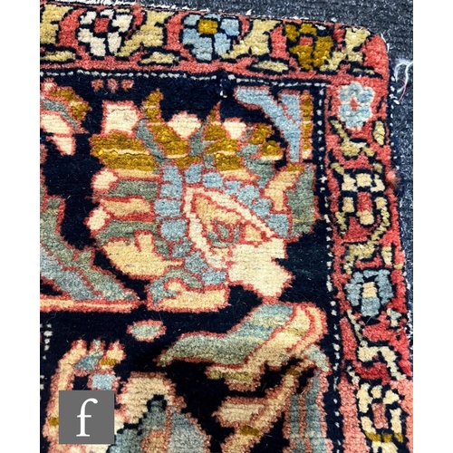 1281 - An early 20th Century Persian 'Tree of Life' pattern rug, on an oatmeal ground within foliate patter... 