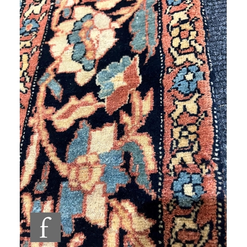 1281 - An early 20th Century Persian 'Tree of Life' pattern rug, on an oatmeal ground within foliate patter... 