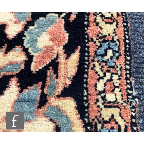 1281 - An early 20th Century Persian 'Tree of Life' pattern rug, on an oatmeal ground within foliate patter... 