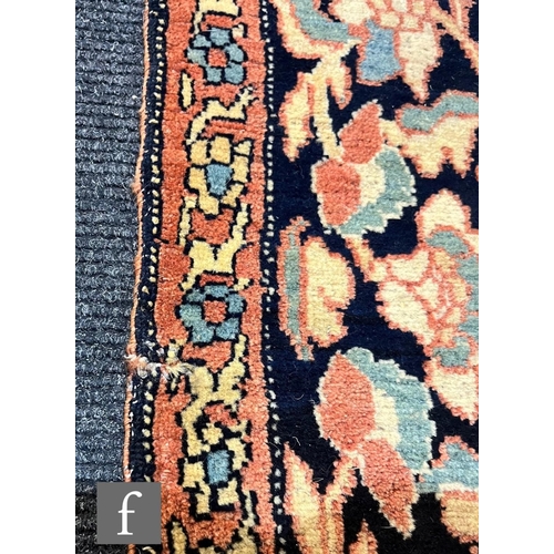 1281 - An early 20th Century Persian 'Tree of Life' pattern rug, on an oatmeal ground within foliate patter... 