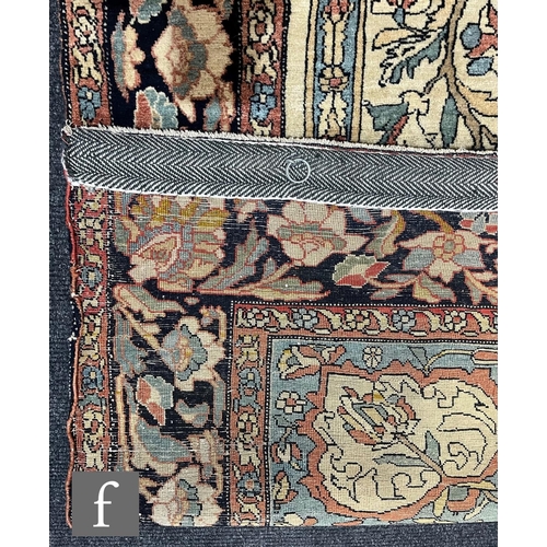 1281 - An early 20th Century Persian 'Tree of Life' pattern rug, on an oatmeal ground within foliate patter... 