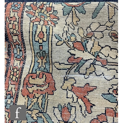 1281 - An early 20th Century Persian 'Tree of Life' pattern rug, on an oatmeal ground within foliate patter... 