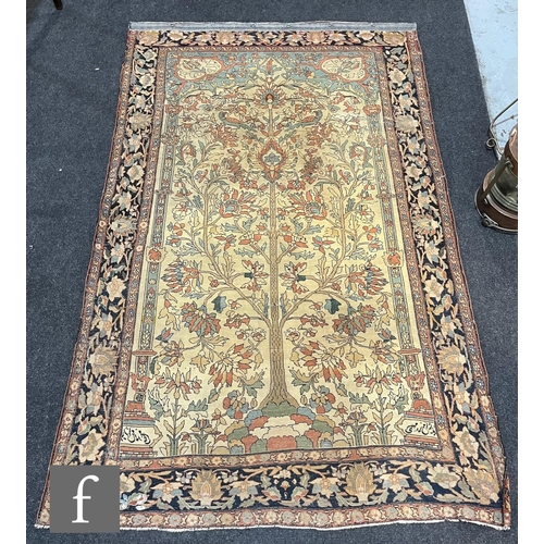 1281 - An early 20th Century Persian 'Tree of Life' pattern rug, on an oatmeal ground within foliate patter... 