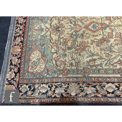 1281 - An early 20th Century Persian 'Tree of Life' pattern rug, on an oatmeal ground within foliate patter... 