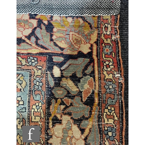 1281 - An early 20th Century Persian 'Tree of Life' pattern rug, on an oatmeal ground within foliate patter... 