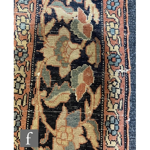 1281 - An early 20th Century Persian 'Tree of Life' pattern rug, on an oatmeal ground within foliate patter... 