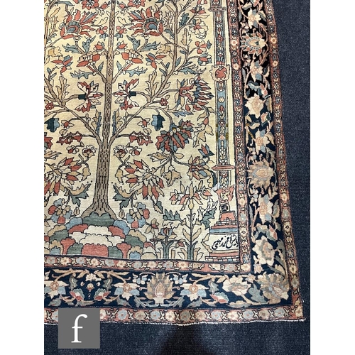 1281 - An early 20th Century Persian 'Tree of Life' pattern rug, on an oatmeal ground within foliate patter... 
