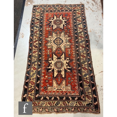 1279 - A Shirvan flat woven rug of deep blue, rust and oatmeal ground colours, with triple medallions to th... 