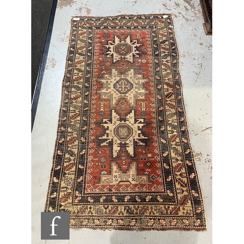 1279 - A Shirvan flat woven rug of deep blue, rust and oatmeal ground colours, with triple medallions to th... 