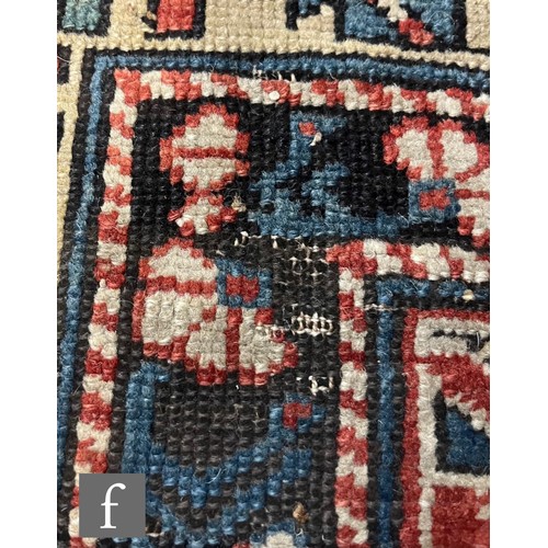 1279 - A Shirvan flat woven rug of deep blue, rust and oatmeal ground colours, with triple medallions to th... 
