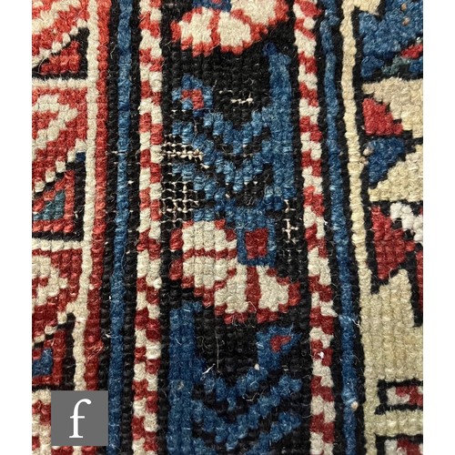 1279 - A Shirvan flat woven rug of deep blue, rust and oatmeal ground colours, with triple medallions to th... 