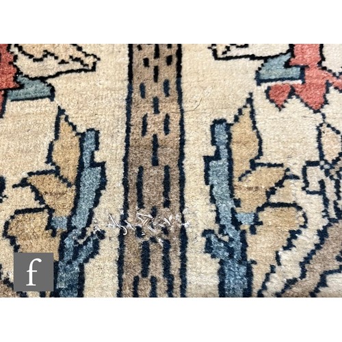 1281 - An early 20th Century Persian 'Tree of Life' pattern rug, on an oatmeal ground within foliate patter... 