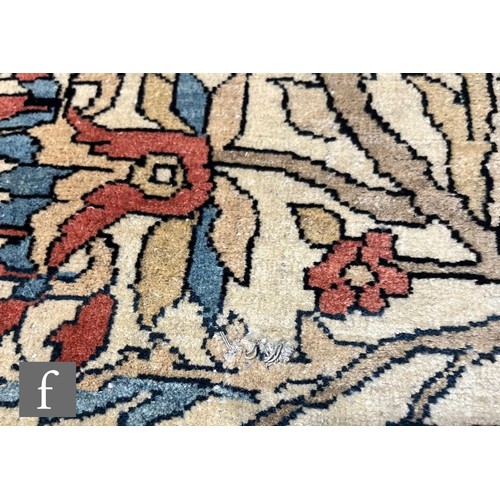 1281 - An early 20th Century Persian 'Tree of Life' pattern rug, on an oatmeal ground within foliate patter... 
