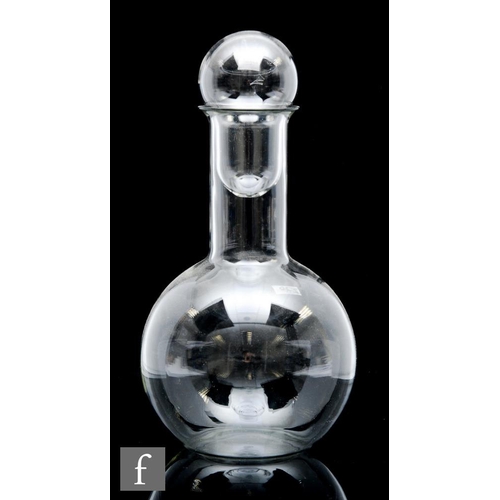 8027 - A 20th Century lightweight glass decanter of globe and shaft form, with hollow blown large globe sto... 