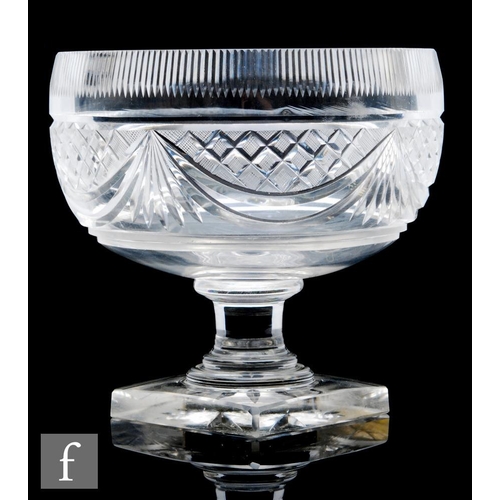 691 - An Anglo Irish clear crystal glass pedestal bowl, of ovoid form, the body with heavily cut swag and ... 