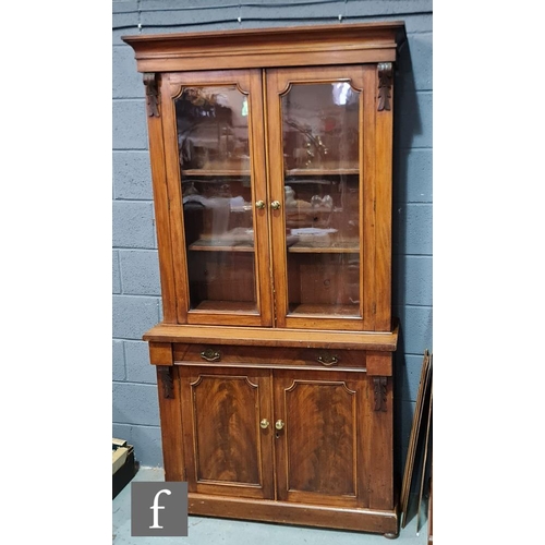 956 - A Victorian walnut cabinet bookcase, with cornice pediment above glazed double doors, acanthus carve... 