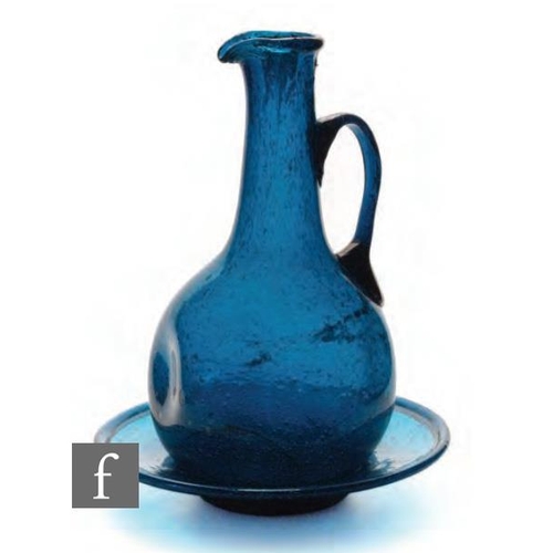 8049 - A 1920s Egyptian glass ewer and dish, the ewer of globe form with dimpled sides and applied handle, ... 