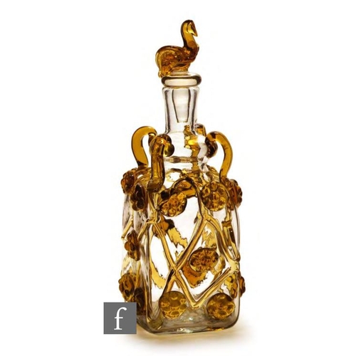 8117 - A 1930s Spanish decanter, the square section body with applied amber zig zags trails and large amber... 