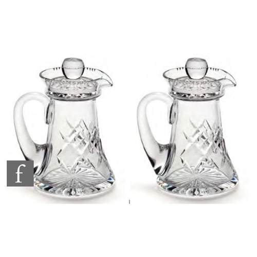 8140 - A pair of Stuart and Sons glass miniature single measure noggin decanters with applied handles, the ... 
