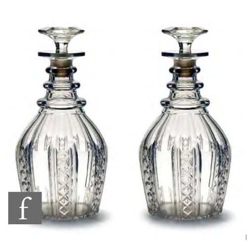 8270 - A pair of Georgian glass decanters circa 1830-1835, each of Prussian form, the body cut with vertica... 