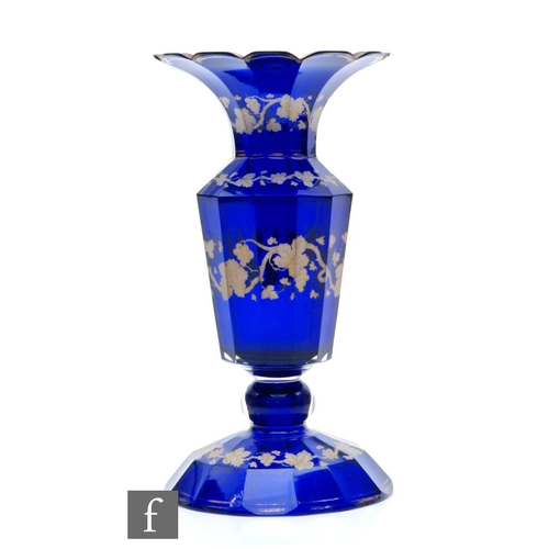 694 - A 19th Century Bohemian glass vase in the manner of Neuwelt, the wide slice cut and domed foot risin... 