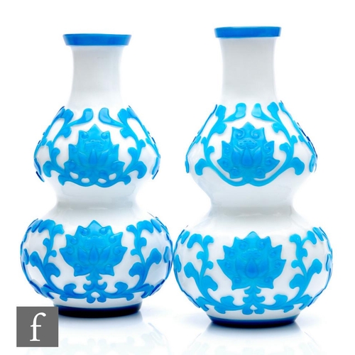 711 - A pair of early 20th Century Peking Cameo glass vases, each of double gourd form, cased in transluce... 