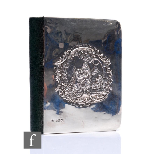 283 - A hallmarked silver fronted green leather daily notebook, decorated with an embossed scene of a cour... 