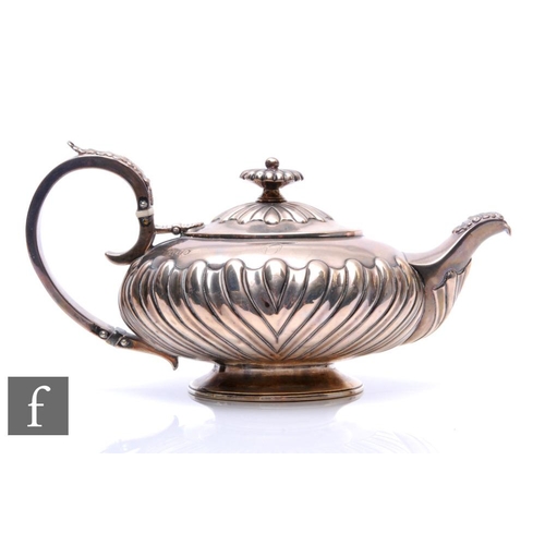 284 - A George IV hallmarked silver melon shape teapot with part fluted embossed decoration, terminating i... 