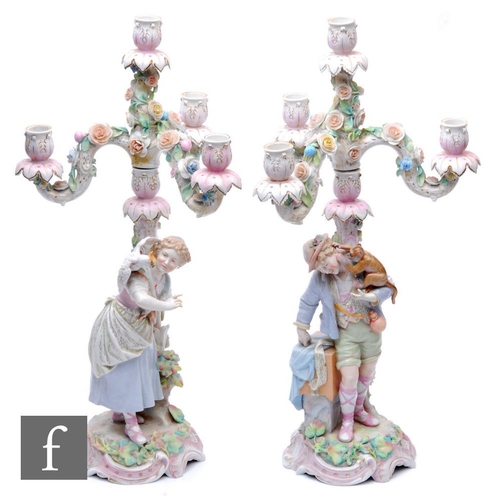 533 - A pair of late 19th Century/early 20th continental porcelain Sitzendorf candelabrum, the central sec... 