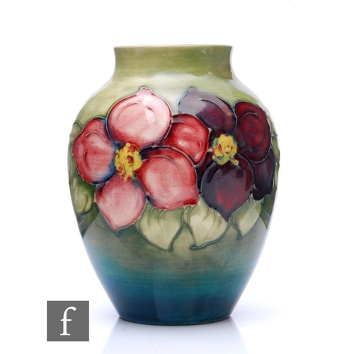 539 - A Moorcroft Clematis pattern vase of tapered ovoid form, the graduated green ground, tubeline decora... 