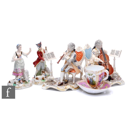 545 - A collection of German porcelain, to include figures of musicians and a rustic male and female surro... 