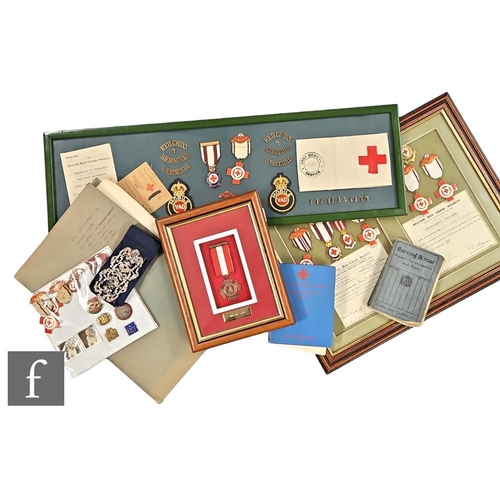 393 - A collection of Red Cross memorabilia to include a framed group of badges awarded to Miss E M Woodwa... 