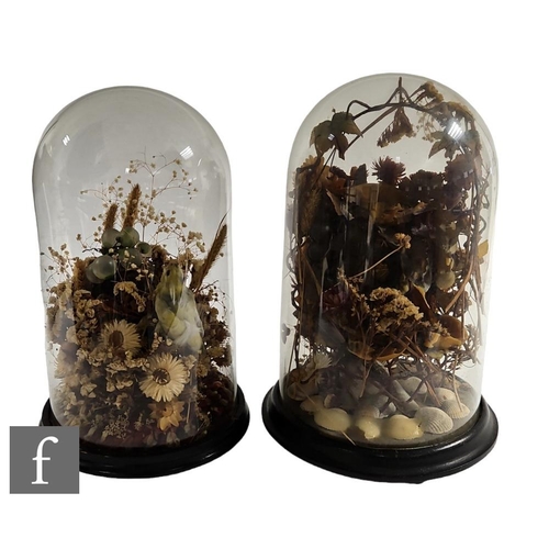 397 - A pair of Victorian still life studies beneath glass domes, to include dried flowers, seashells, a t... 