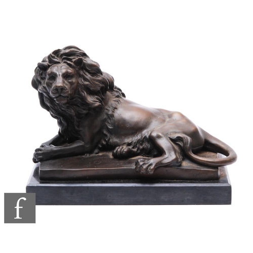 401 - A 20th Century bronze study of a recumbent male lion, After Baryle, on plinth base, width 29cm.