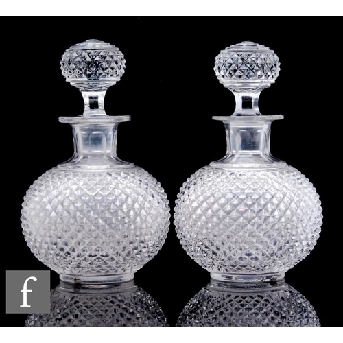 909 - A pair of 20th Century Baccarat clear crystal decanters, of squat ovoid form with short collar neck,... 