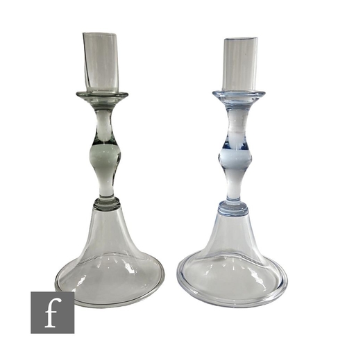 914 - A near pair of mid 20th Century crystal glass candle sticks in the manner of Whitefriars, the cylind... 