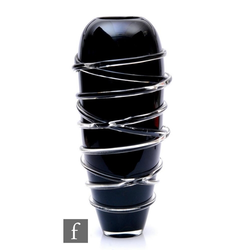 826 - A large contemporary black glass vase of tapered ovoid form decorated with clear crystal trailed lin... 