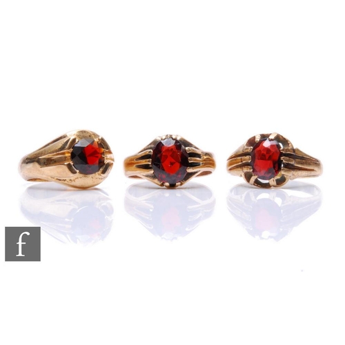 1 - Three 9ct gentleman's single stone garnet rings, total weight 17.5g, all claw set to reeded shoulder... 