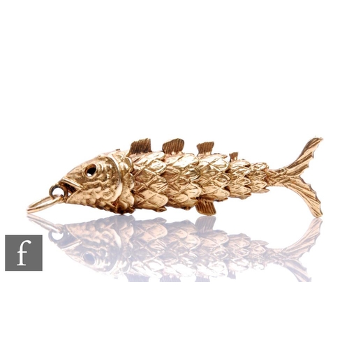 109 - A 9ct hallmarked pendant modelled as an articulated fish, weight 19g, length 6cm, terminating in pen... 