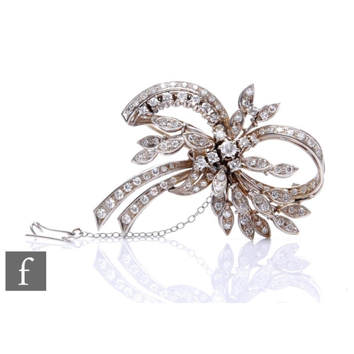 124 - A mid 20th Century 18ct white gold diamond spray brooch with brilliant cut stones to a leaf and bow ... 