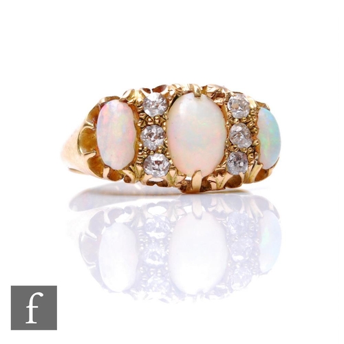 153 - An early 20th Century 18ct hallmarked opal and diamond nine stone ring, three oval opals spaced by t... 