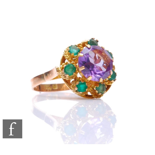 157 - A 14ct amethyst and emerald cluster ring, central circular claw set amethyst within a seven stone em... 